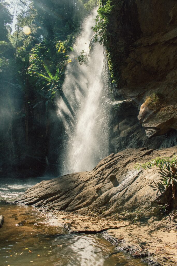 A stunning waterfall cascading in a lush Chiang Mai forest.