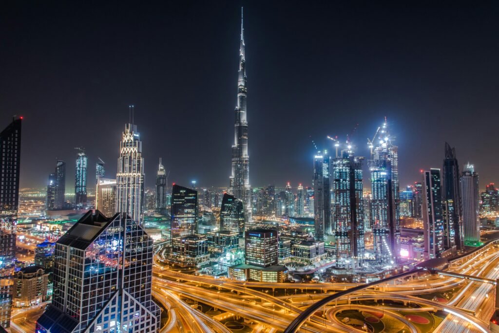 A stunning view of Dubai's illuminated skyline featuring the towering Burj Khalifa at night.