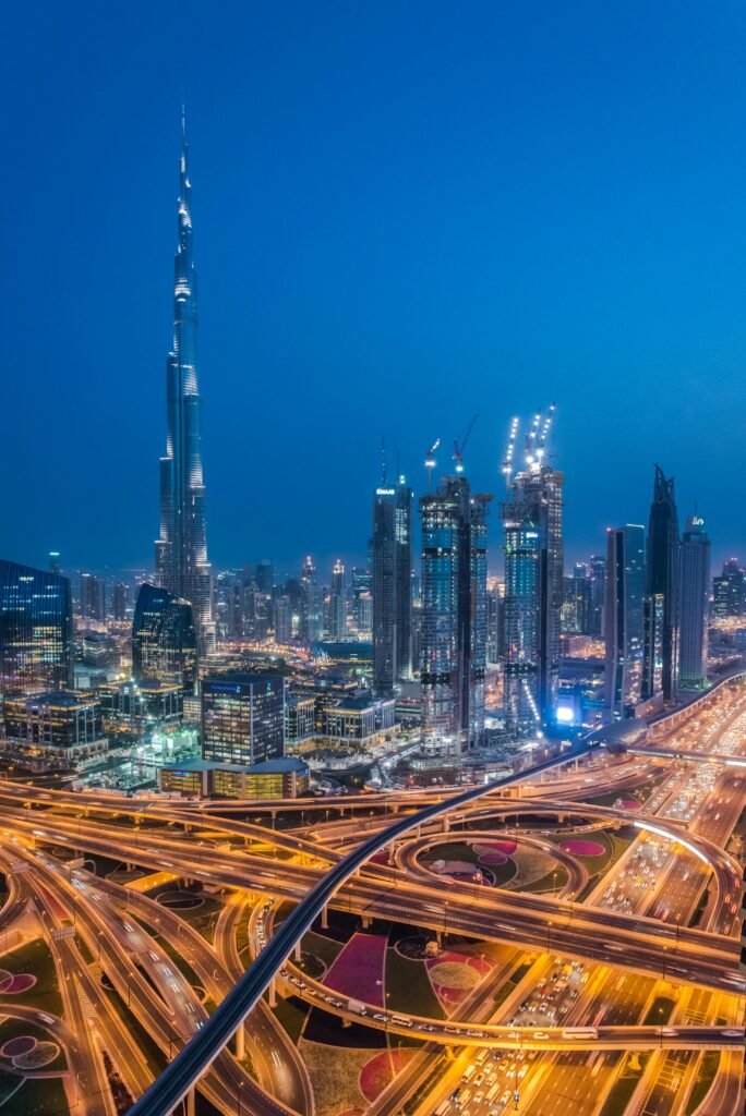 A breathtaking aerial view of Dubai's skyline with Burj Khalifa lit at night.