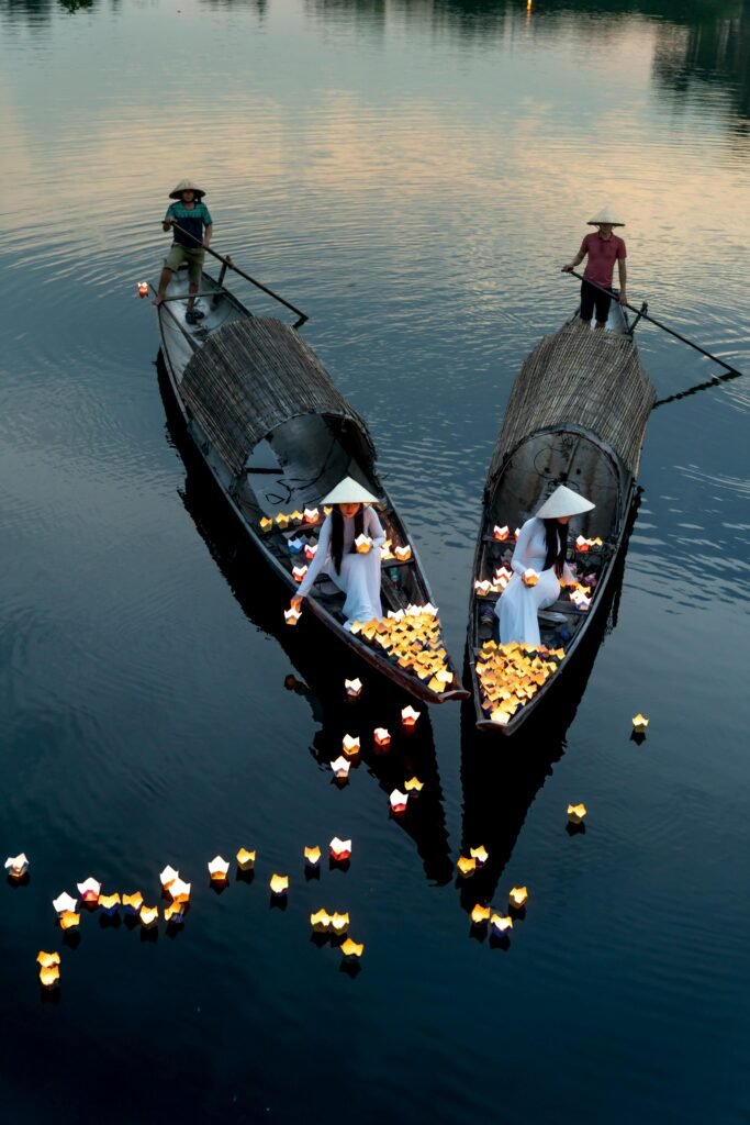 Scenic view of traditional lantern boats on the tranquil Perfume River in Hue, Vietnam.