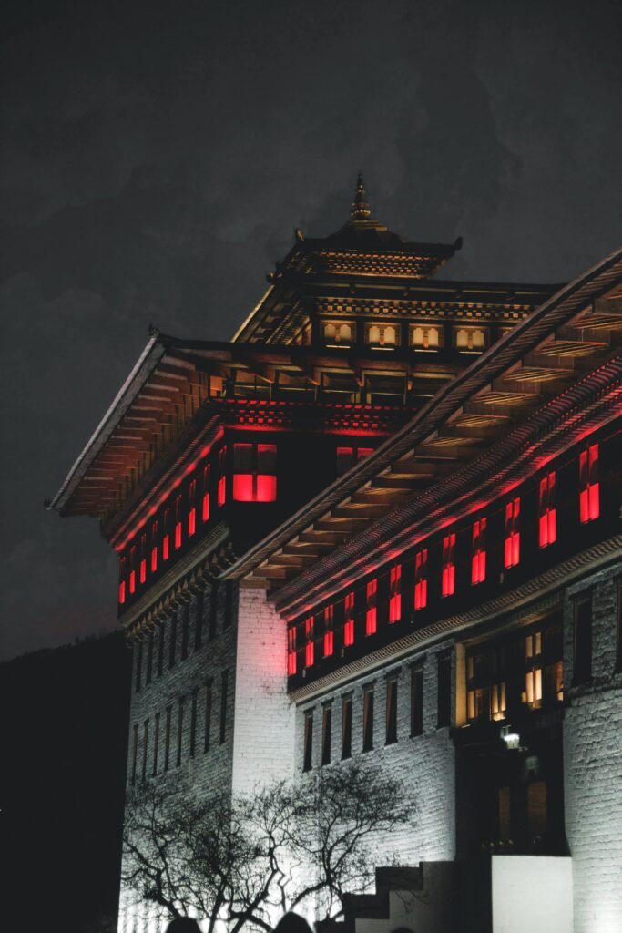 A captivating night shot of Thimphu architecture with illuminated windows, highlighting Bhutanese heritage.